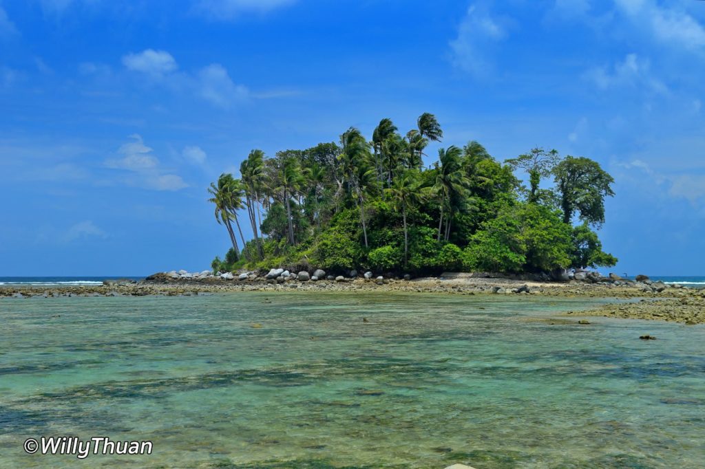 a small island with coconut trees in front of Nai Yang Beach