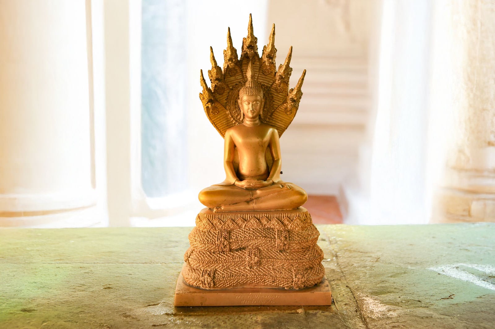 Saturday Buddha posture Pang Nak Prok (ปางนาคปรก) - seated under seven-headed Naga serpent